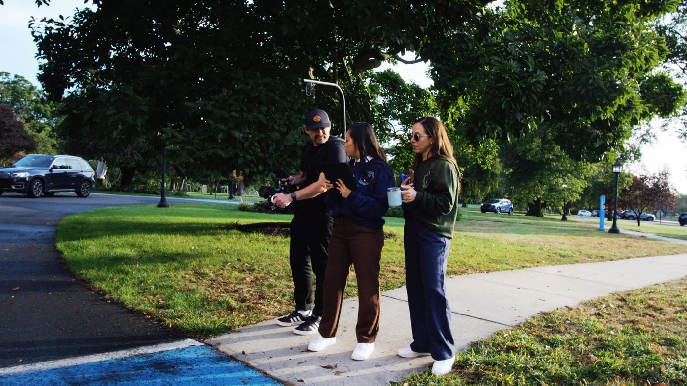 A School Storytellers crew filming students walking across campus