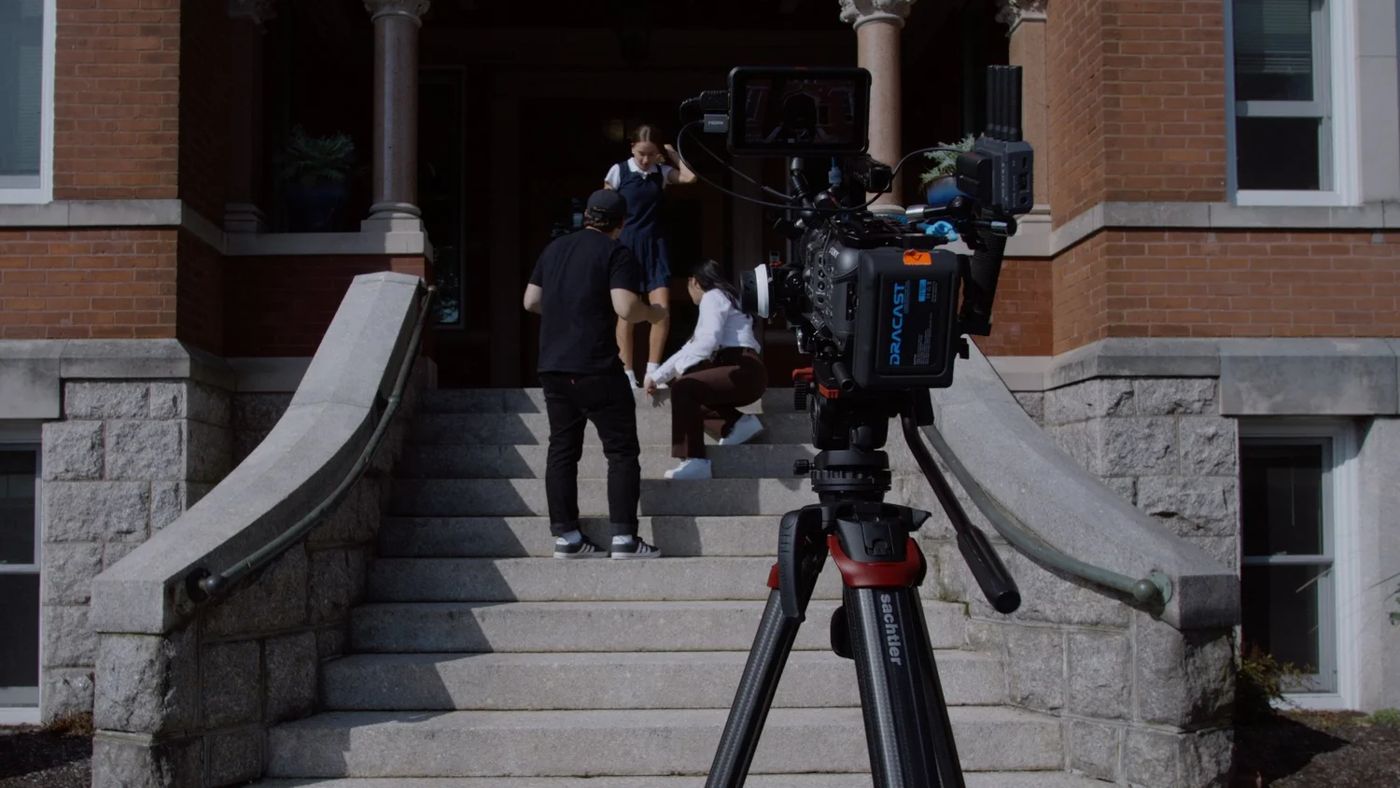 Filming on the front steps of a school